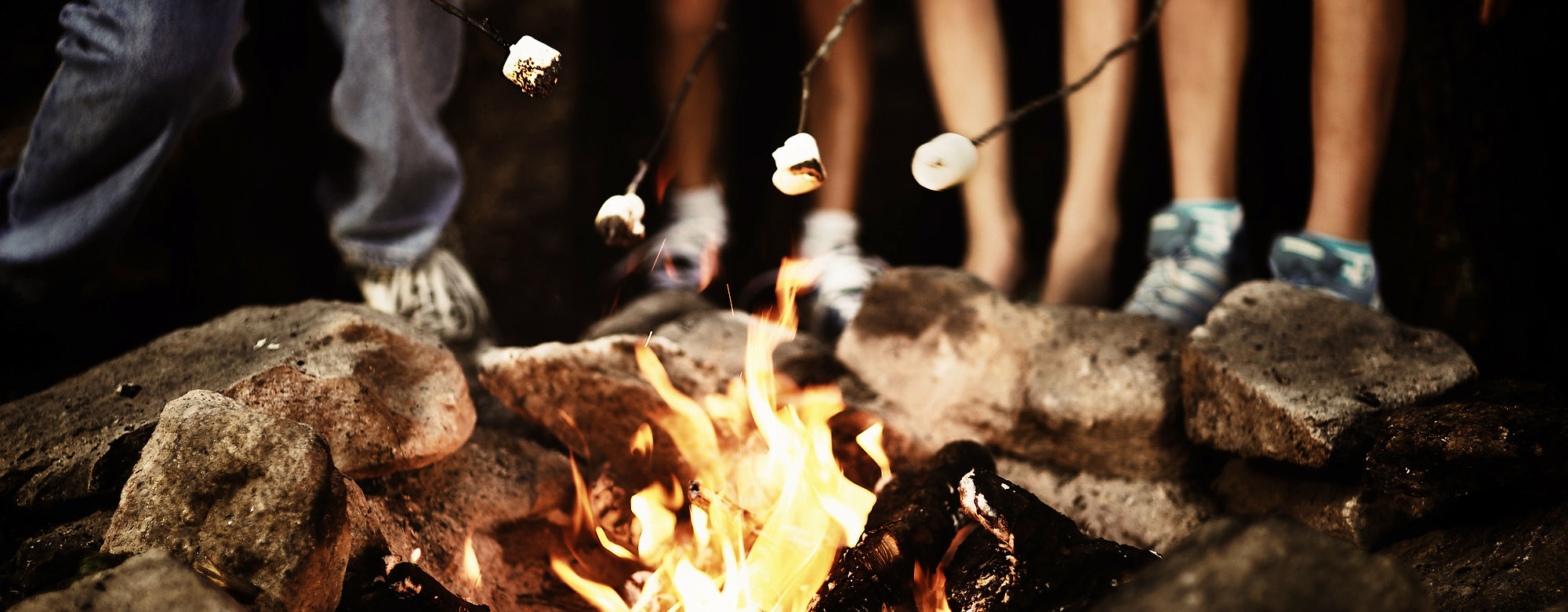 Friends gathered around a campfire
